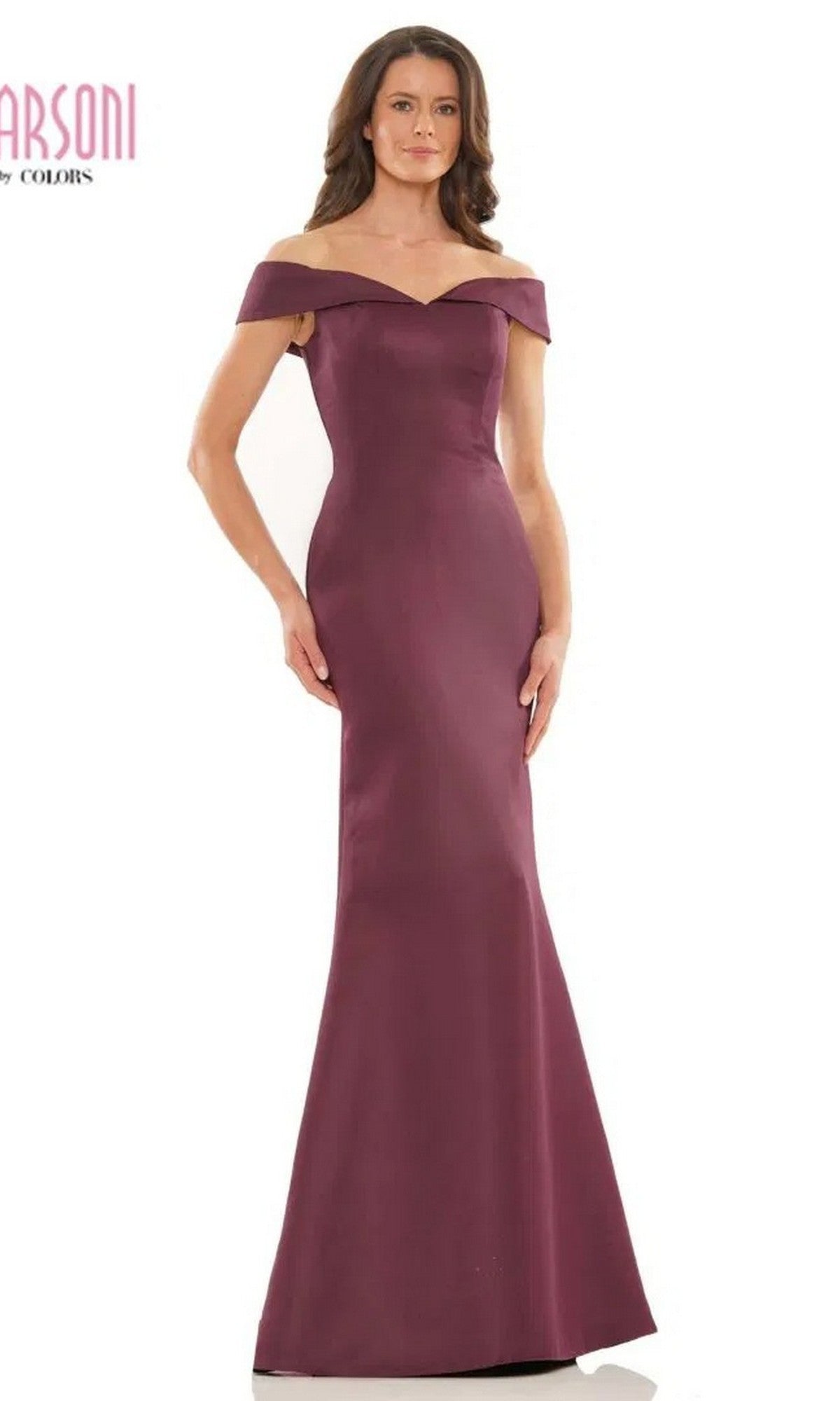 A woman poses against a plain white background, wearing the Marsoni MV1153 Long Formal Dress in wine—a perfectly fitted, elegant, off-the-shoulder evening gown with a floor-length satin finish.